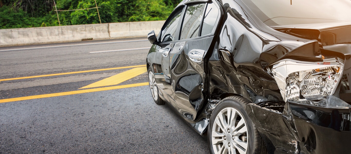 wrecked car Lafayette Louisiana Personal Injury Accident Lawyers Wright Roy with a black wrecked vehicle