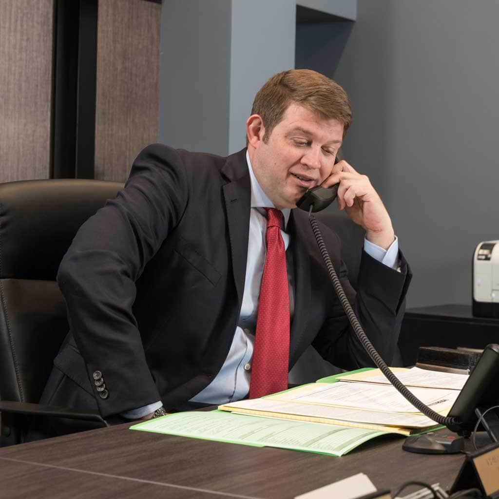 Lafayette Louisiana Wright Roy Personal Injury AttorneyJohn P Roy on the phone in the conference room