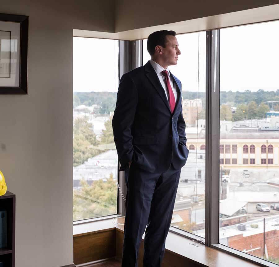 lafayette louisiana personal injury lawyer andrew quackenbos inset gazing out of the window