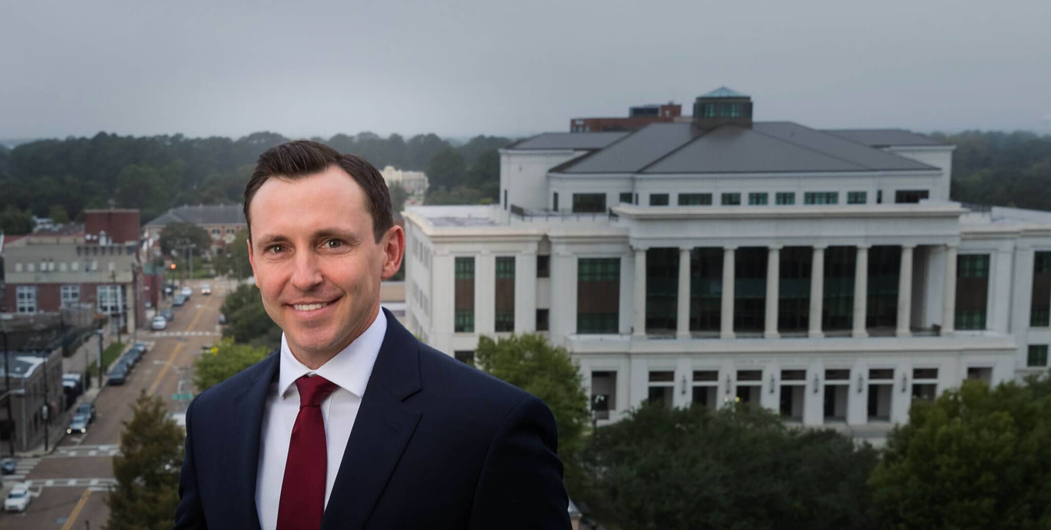 lafayette-louisiana-personal-injury-attorney-andrew-quackenbos-headshot-v3 Andrew Quackenbos Lafayette Louisiana Personal Injury Attorney on deck overlooking federal courthouse
