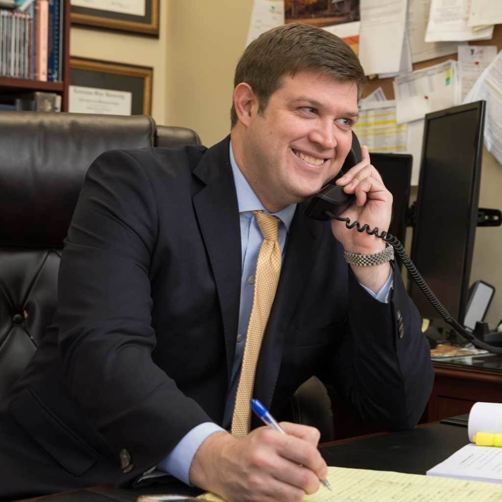 John P Roy Lafayette Louisiana Wright Roy Personal Injury Attorney smiling while on the phone