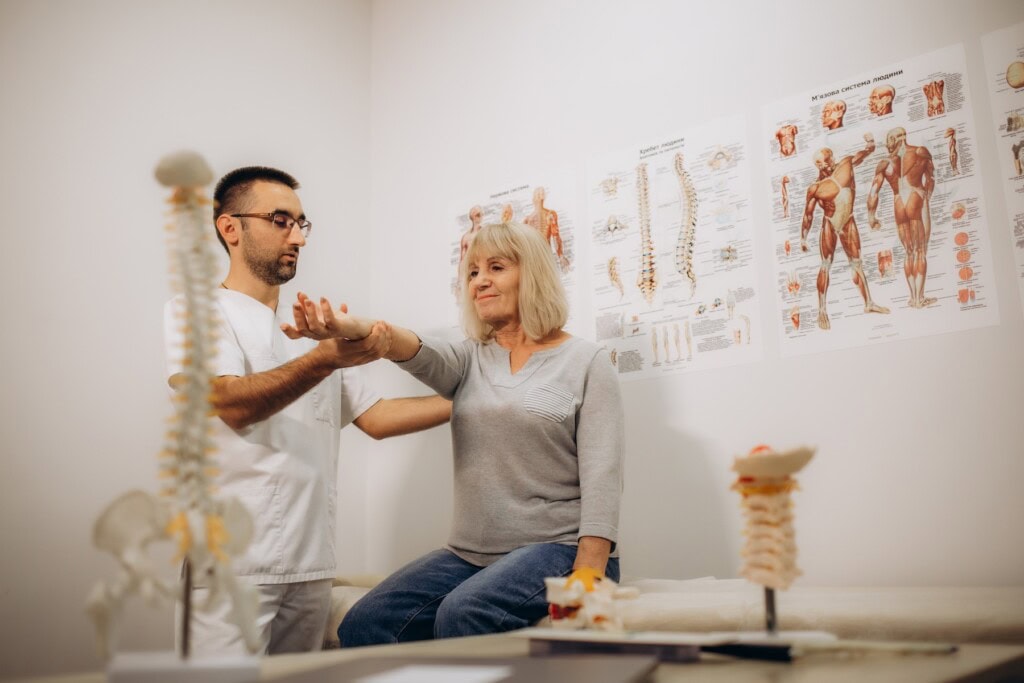 Senior woman getting a neck adjustment done in the medical office