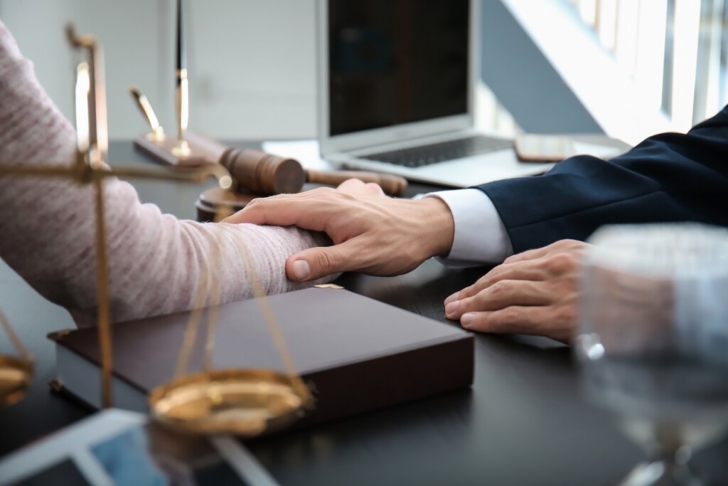 Lawyer having meeting with client in office, closeup